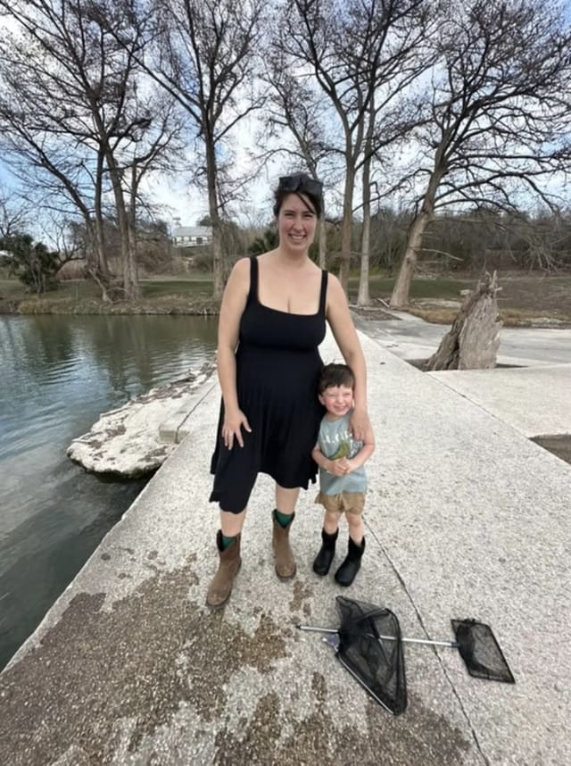 Laura and their son on a river dam under cypress trees
